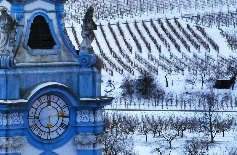 Spire Of Durnstein Monastery With Vineyards In The Background - Austria