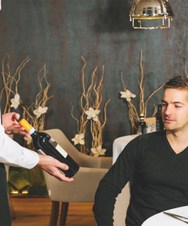 The Real Reason Why Restaurant Servers Present Wine Bottles