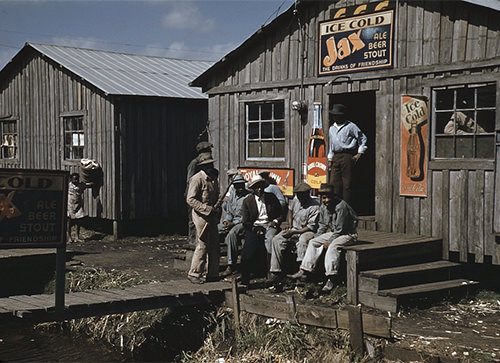 Migratory laborers outside of a "juke joint" during a slack season, Belle Glade, Florida in 1941