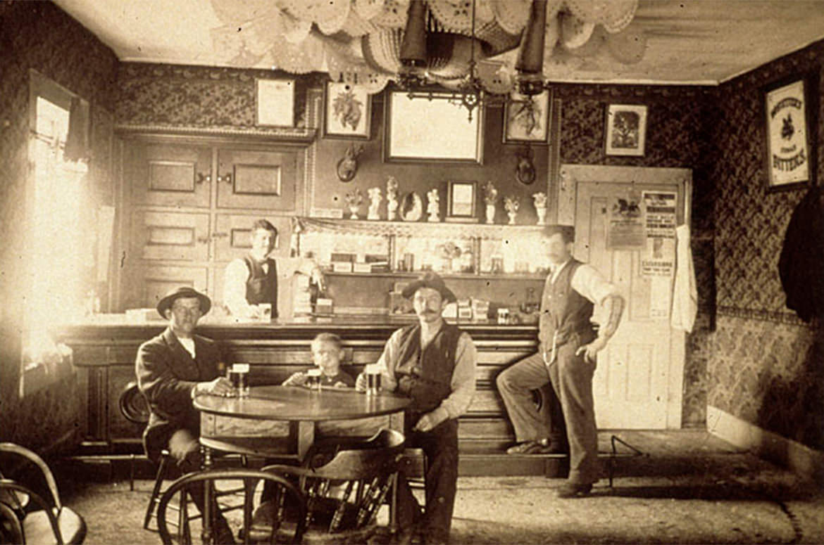At this Old West saloon, a child is drinking a beer.