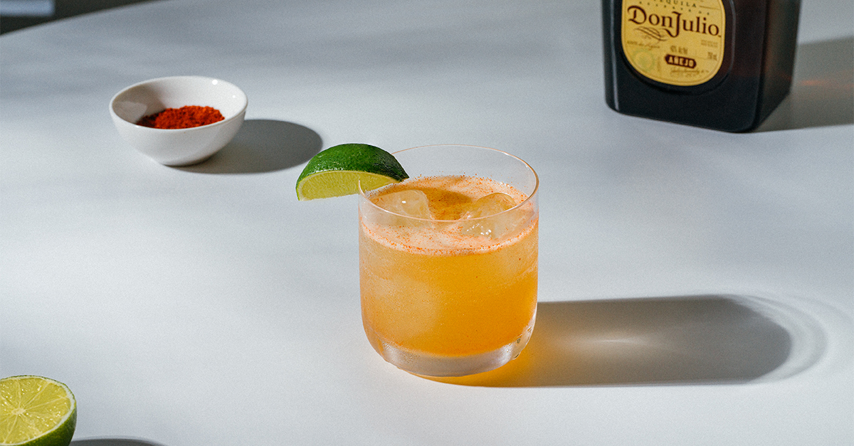 Pour Don Julio Ańejo Tequila, Orange Liqueur, Lime Juice, Simple Syrup, and Chili Powder into an ice-filled cocktail shaker. Shake until combined. Strain into an ice-filled rocks glass. Garnish with a lime wedge. Salt or sugar rim optional.