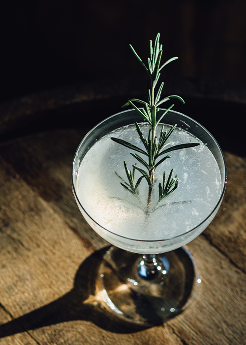 This cocktail is a savory twist of the classic gimlet, and the gin is paired with the rosemary herb.