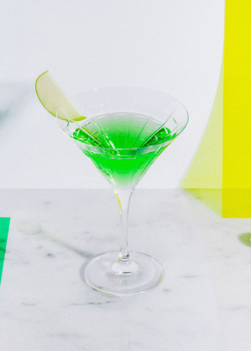 the apple martini is bright green and festive for the holiday