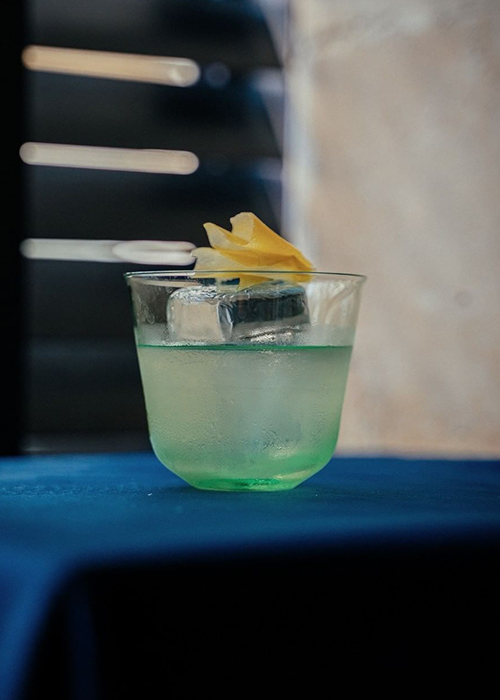 The sea blue-green colored cocktail from The Little Red Door in Paris is an example of a cocktail's color impacting the emotional impulse behind ordering a drink.