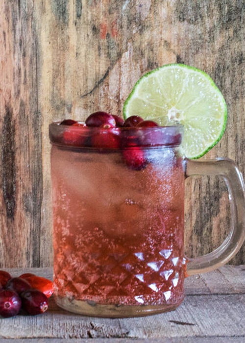 The Cranberry Moscow Mule adds cranberry-infused simple syrup to the classic cocktail mixture in this Mule variation.