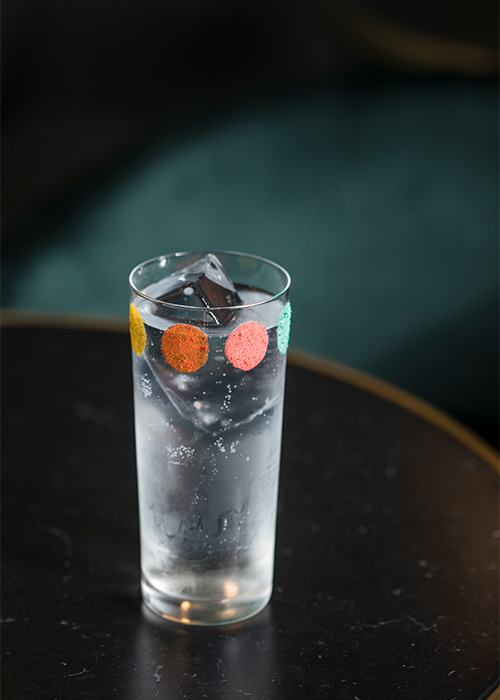 Drink garnishes are coming in full circles lately with spots, dots, discs, drops, and orbs sitting inside, resting atop, and decorating the rims of our glasses. 