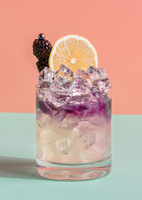 The Bramble is garnished with blackberries and a lemon wheel