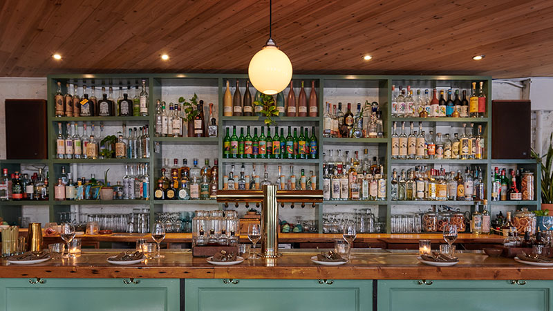 Image of the back bar at Bar Lula, which features a number of tequilas from small producers.