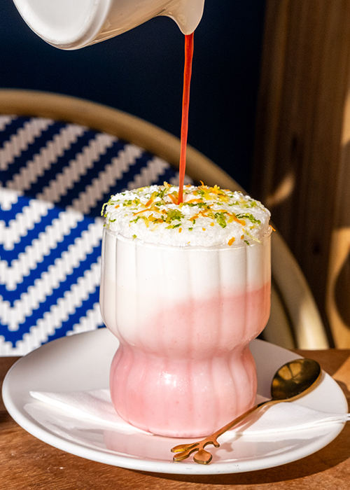 Causwell's soufflé cocktail blends egg whites, cream, tarragon-infused gin, blood orange, and citrus until frothy. 