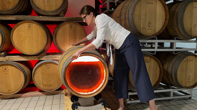 Marsi with a demo barrel, which spins Sagrantino grapes horizontally several times a day. 