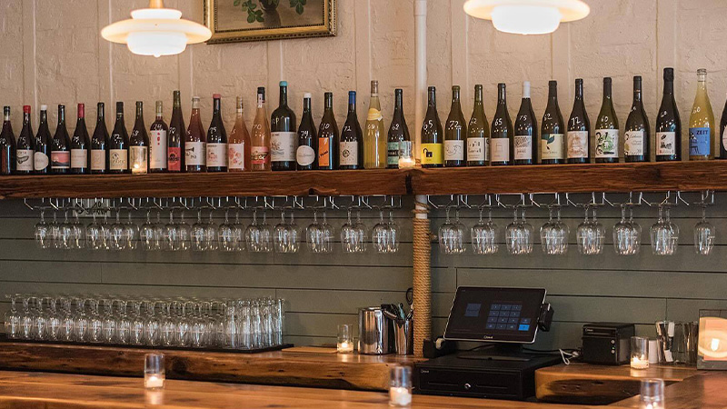 At Bouquet Wine Bar, printed wine lists have been ditched in favor of bottle displays. 