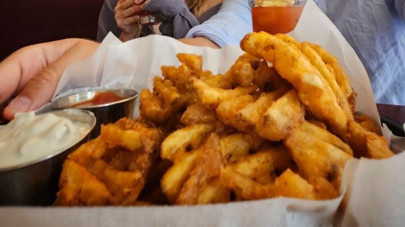 Mother’s Ruin's Old Bay waffle fries is one of the best bar snacks in New York City.