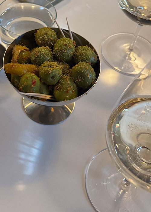 With Others' marinated castlevetrano olives is one of the best wine bar snacks in NYC.